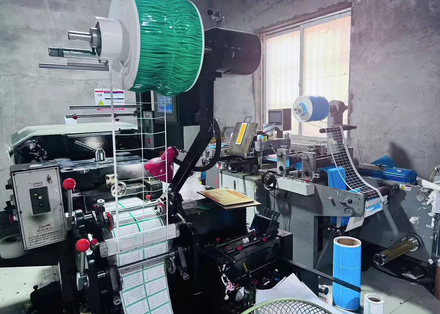 Real label printing and converting workspace with material rolls